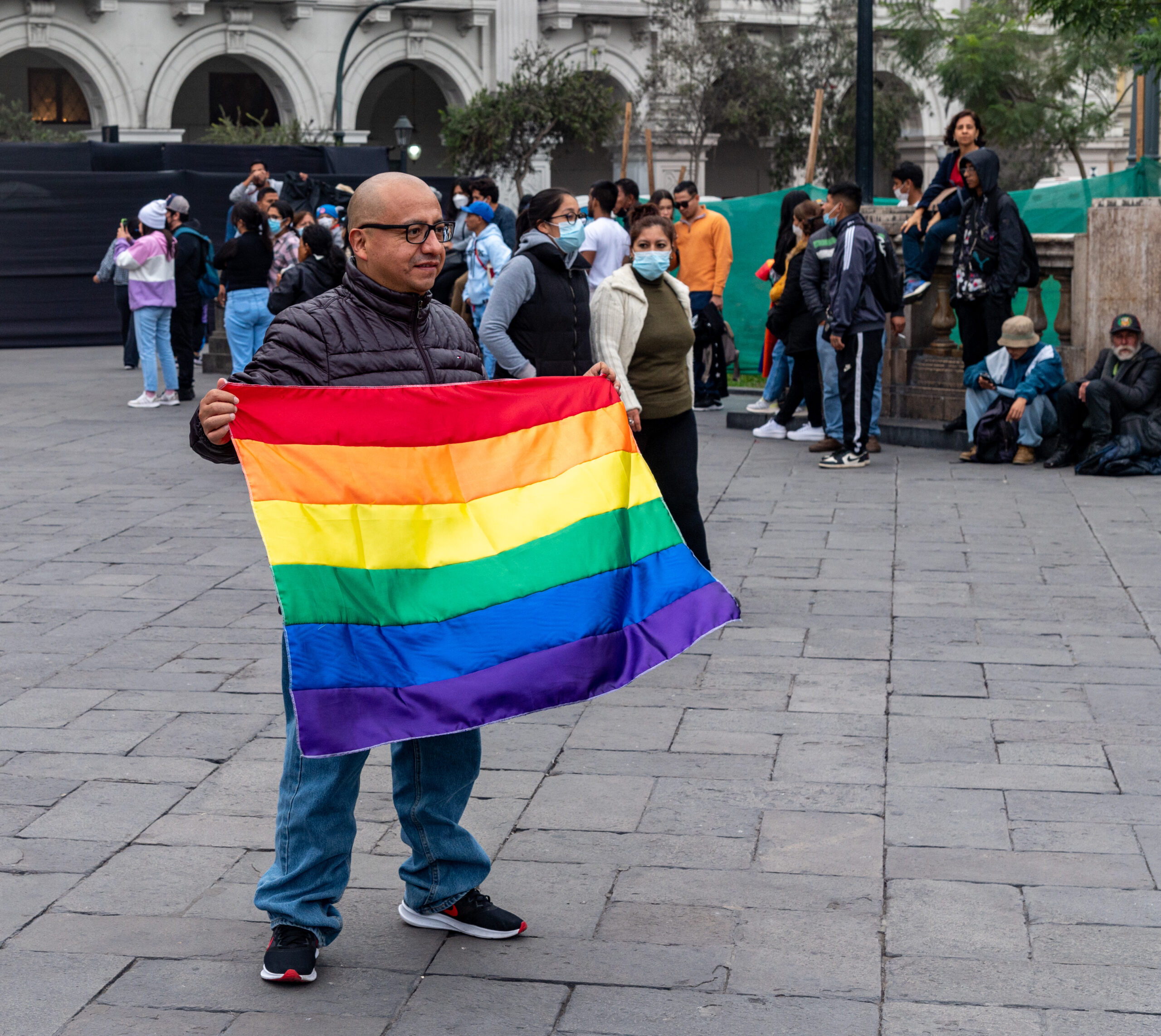 Pride in Peru man with rainbow flag lima plaza san martin