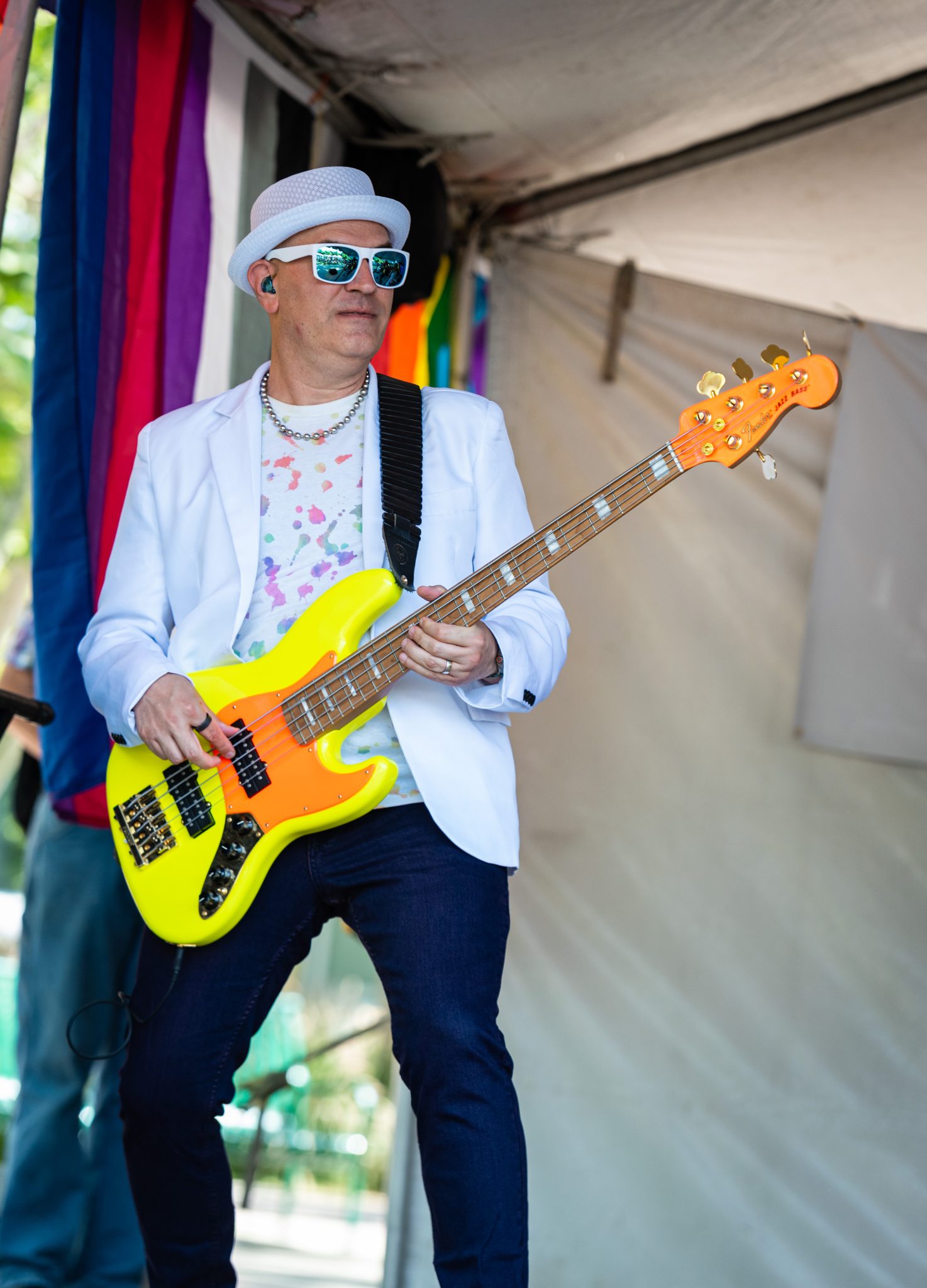 Tainted Love, bass player, 1980's cover band, orange and yellow, davis pride, davis, california, pride month, gay community, event, chris allan, freelance photojournalist, news photography, lgbtq, event, colorful