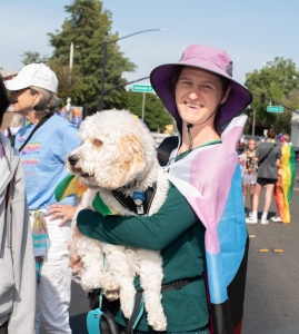 trans flag, dog, person, smiling, portrait, reporter, news event, small town, central valley, colorful photos, photography, photographs, Woodland California, Woodland, Yolo County, Pride parade, pride march, downtown, june 2023, chris allan, lgbtq, community, event, photojournalist