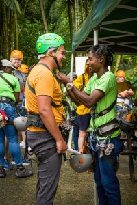 Vert-guide-helping-zipliner-rainforest-adventures-Saint-Lucia-4304